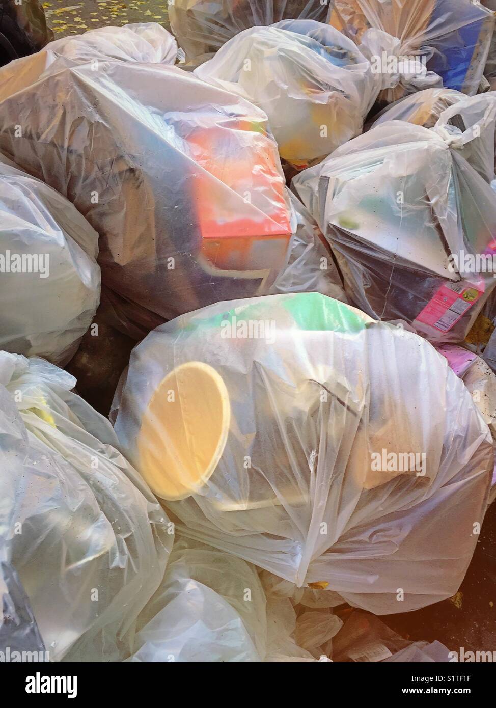 Huge plastic bags of garbage on the sidewalk in New York City, USA