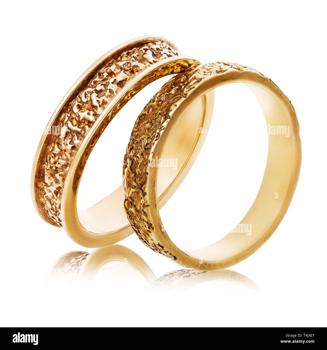 Two Gold Wedding Rings With An Abstract Surface Isolated On A White