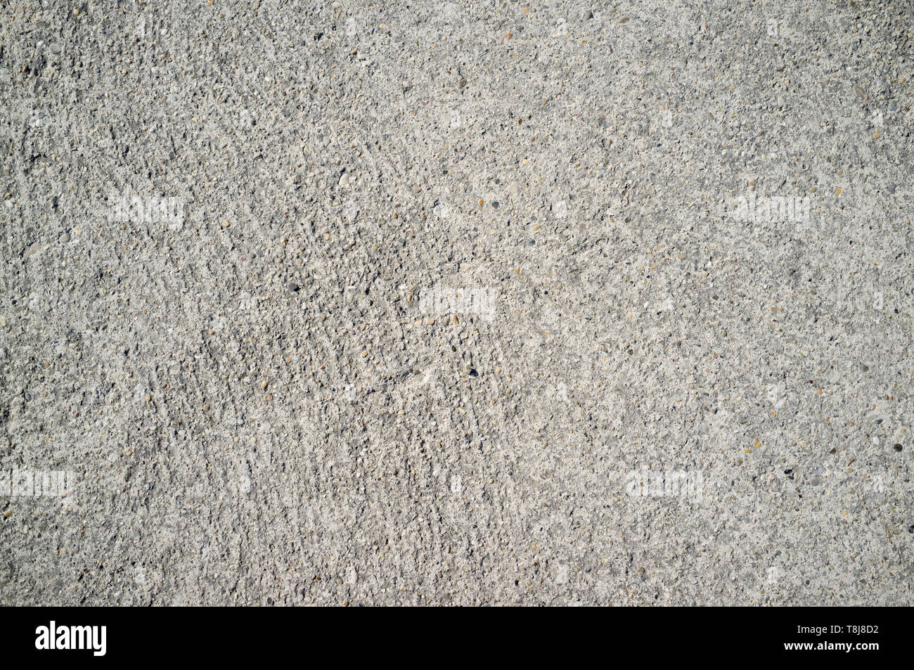 Texture Of Old Weathered Concrete Wall With Small Rocks On Direct