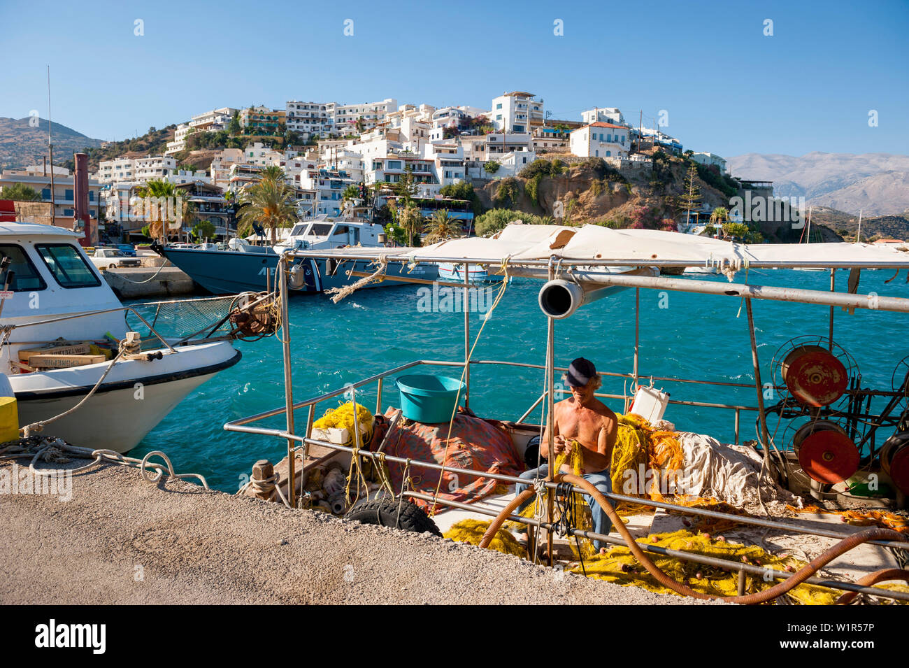 Fisherman And Fishing Boat In The Harbour Agia Galini Crete Greece