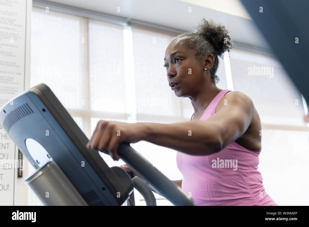 Mature Woman Exercising On Elliptical Machine Stock Photo Alamy