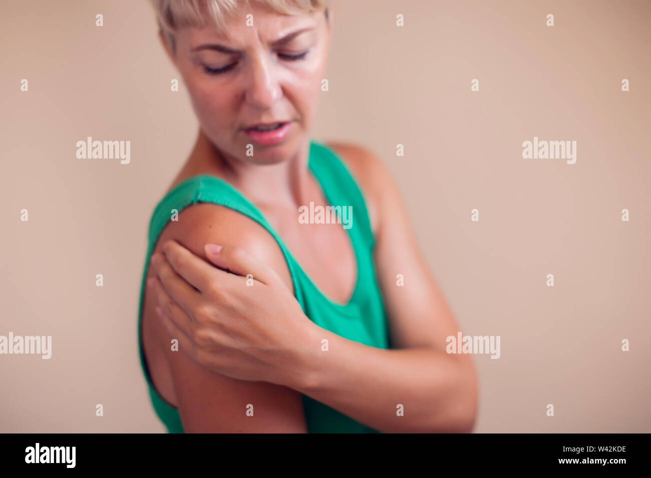 Woman With Short Hair Feels Strong Pain In Shoulder Isolated People