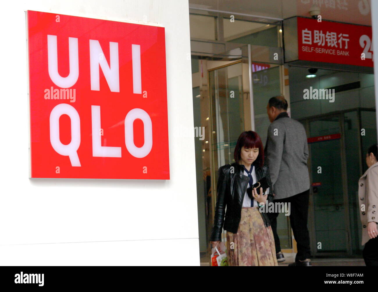 File Chinese Customers Walk Into Or Exit A Fashion Store Of Uniqlo