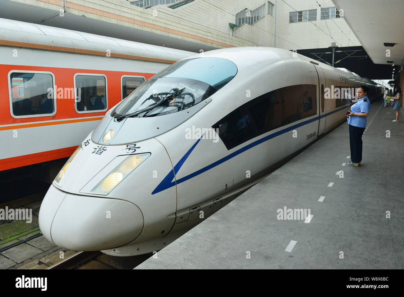 File A Train Conductor Stands Next To A Crh China Railway High