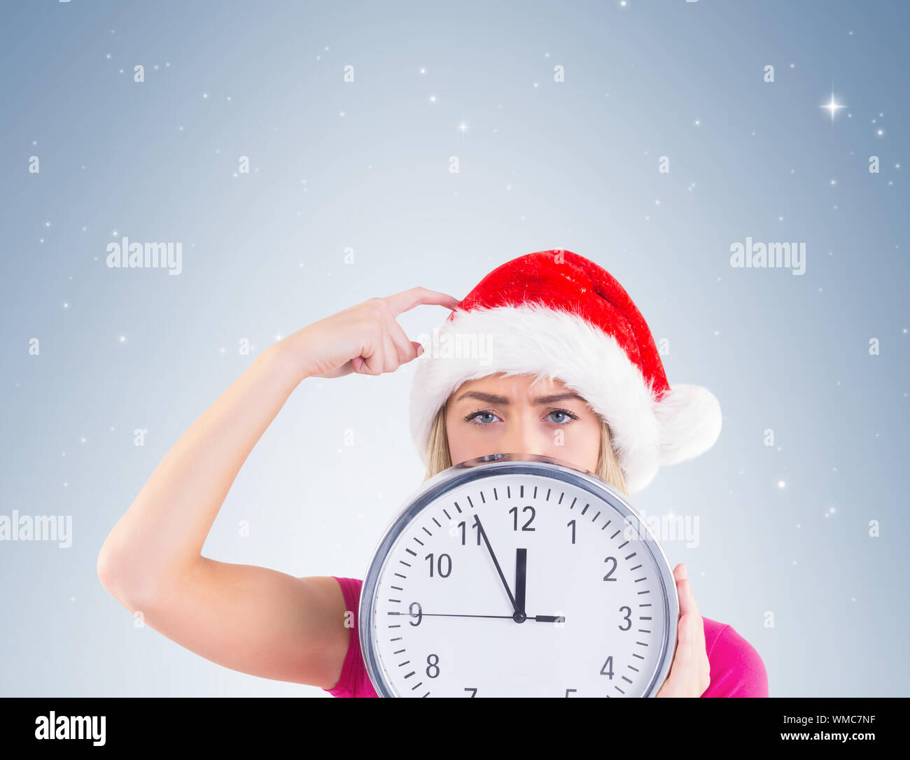 Festive Blonde Showing A Clock On Vignette Background Stock Photo Alamy