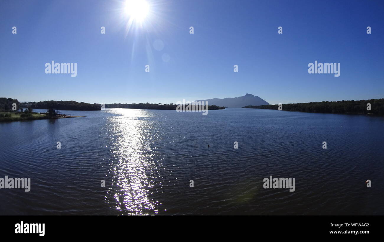 Sun Shining Through Clouds Over Sea Stock Photo Alamy