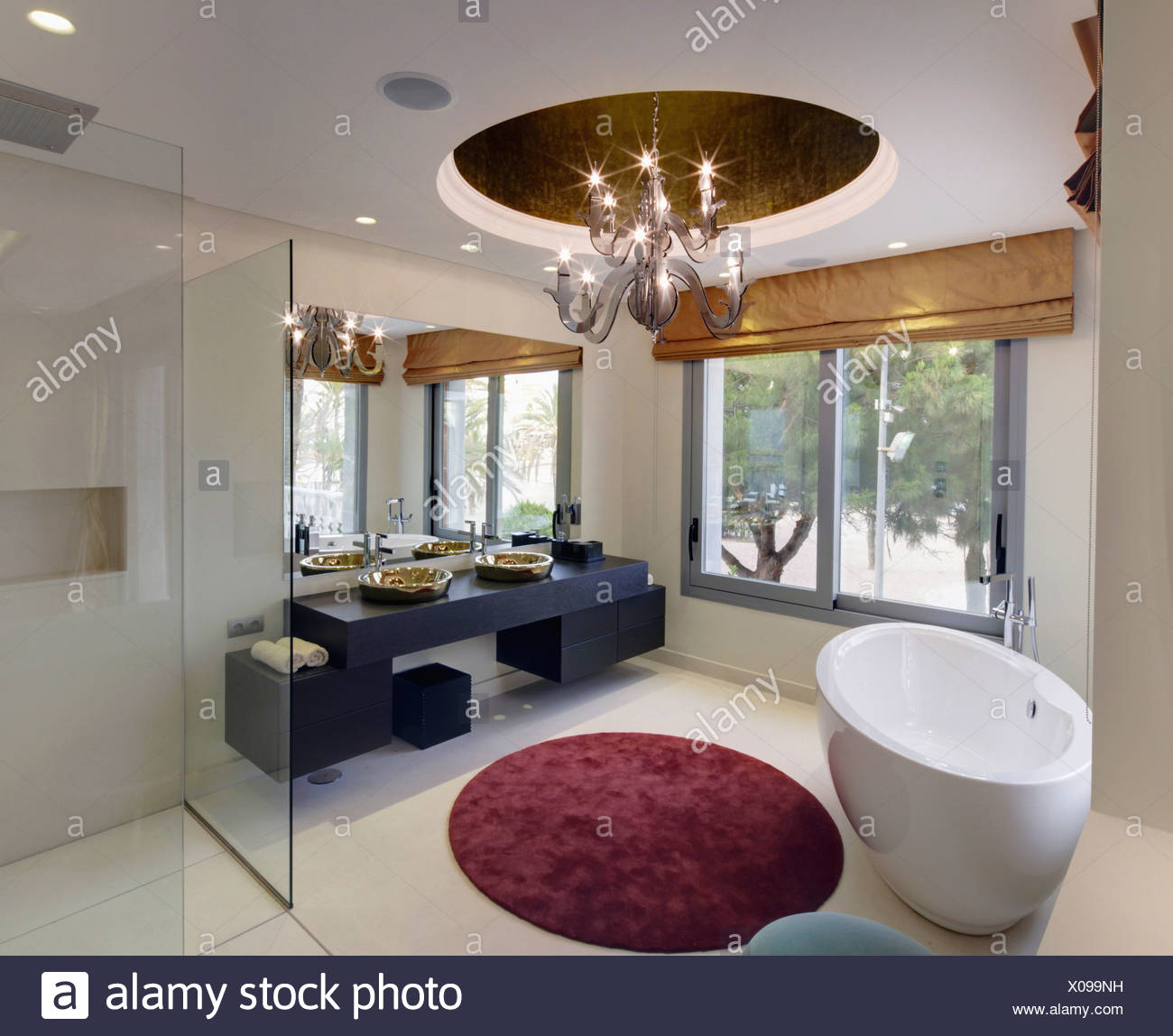 Oval Freestanding Bath And Circular Rug In Modern Bathroom With Oval Freestanding Bath And Circular Rug In Modern Bathroom With Central Light Fitting Large Windows