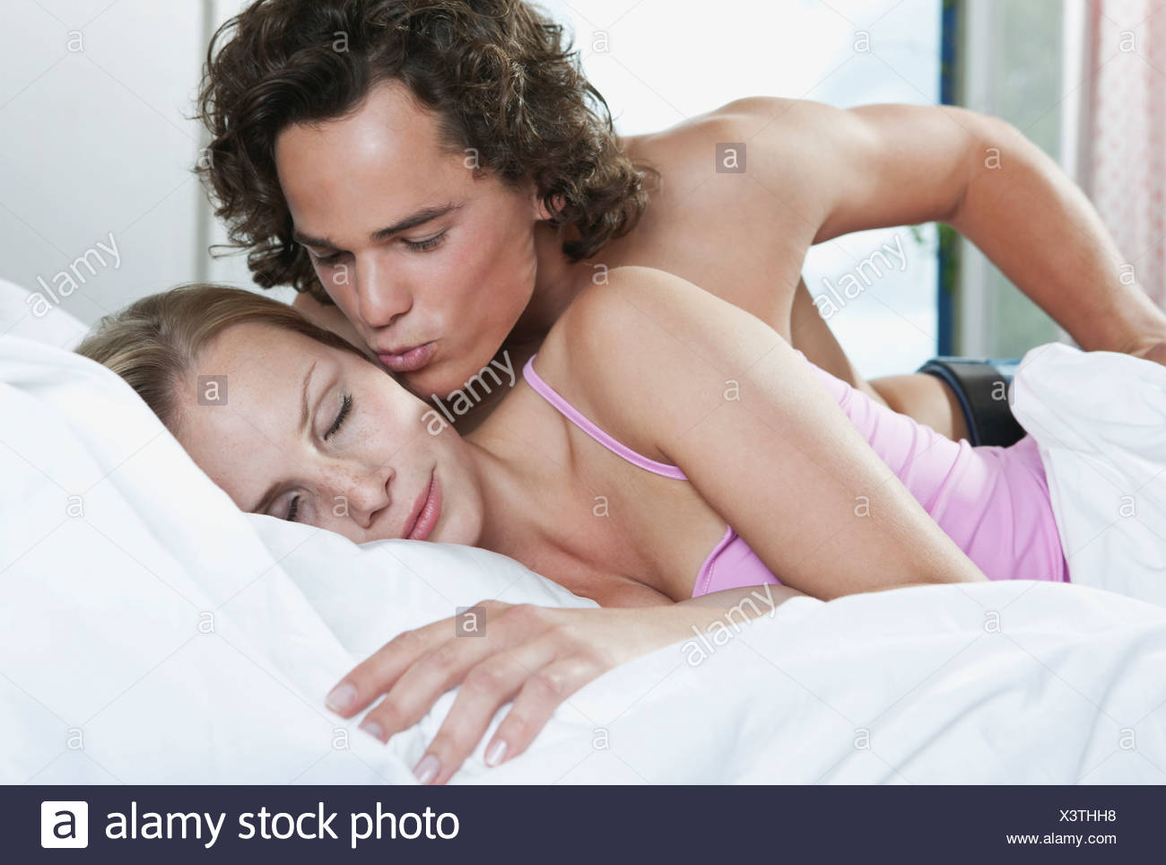 italy tuscany young couple romancing on bed in hotel room stock