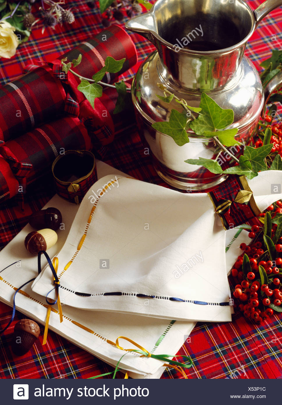close up of drawn thread work linen napkins on christmas table with tartan cloth and pewter jug - Christmas Napkins Cloth close up of drawn thread work linen napkins on christmas table with tartan cloth and pewter jug - Christmas Napkins Cloth