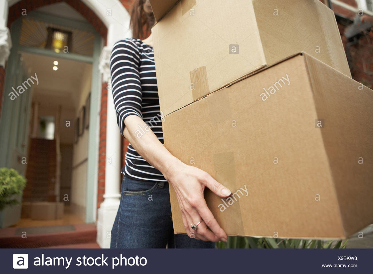 Woman Carrying Heavy Boxes High Resolution Stock Photography And Images