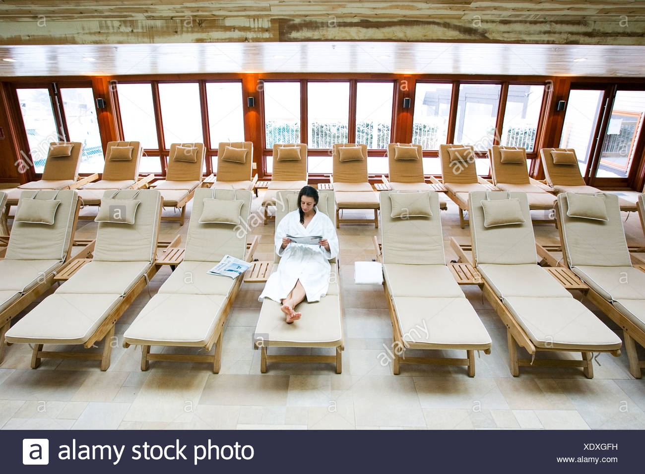 reading chaise lounge dark blue woman in white robe reading chaise lounge by the indoor pool at spa stowe vt reading chaise lounge dark blue woman in white robe reading chaise lounge by the indoor pool at spa stowe vt