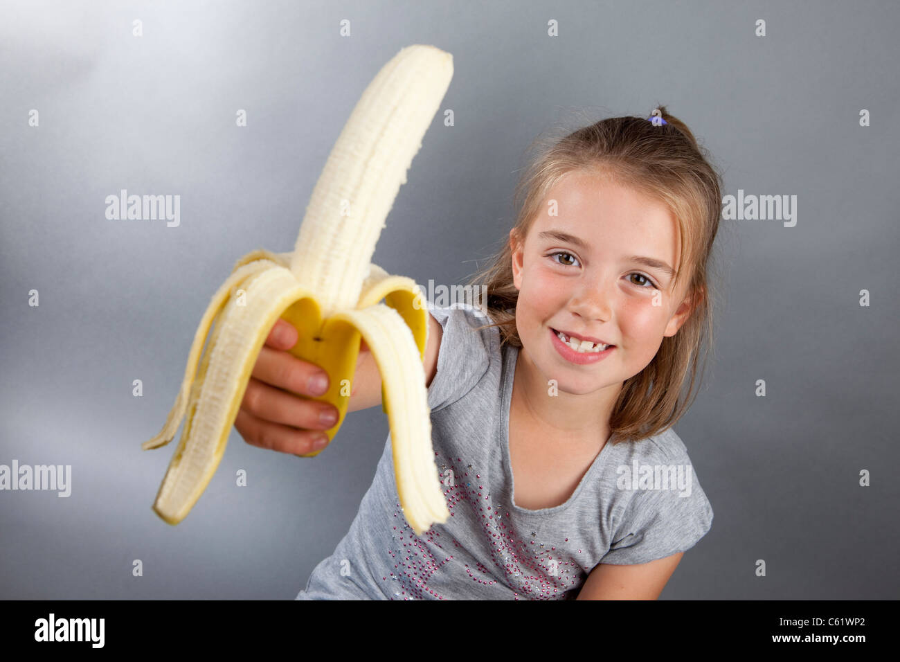 Girl with sexy figure saddled banana
