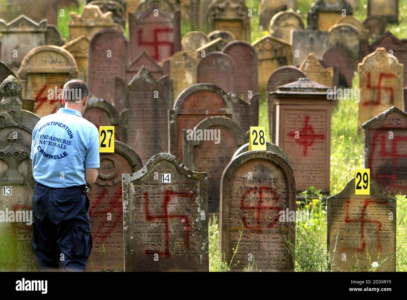 A French Gendarme Inspects Some Of The Graves Desecrated By Vandals