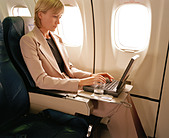 woman-with-laptop-on-plane-A1BAD4.jpg