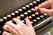 hands-on-typewriter-close-up-AT6E7R.jpg