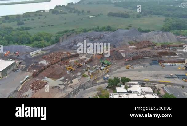 Large construction area displays piles of materials, machinery ...