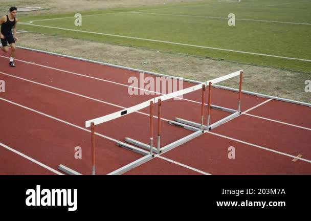 Athletic Fit Couple Man and Woman Hurdling in the Stadium. Jumping Over ...