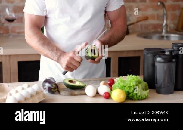 mans-hands-peeling-an-avocado-as-part-of-morning-routine-for-healthy