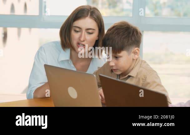 Smart boy playing laptop with multicultural friend learning prompt at ...