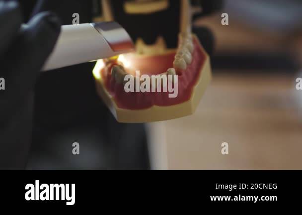 Customer Teeth Dental care. Close-up of dental technician in laboratory working on ...