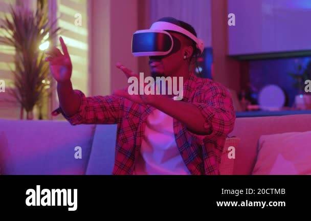 African american man wearing VR glasses experiencing virtual simulation ...