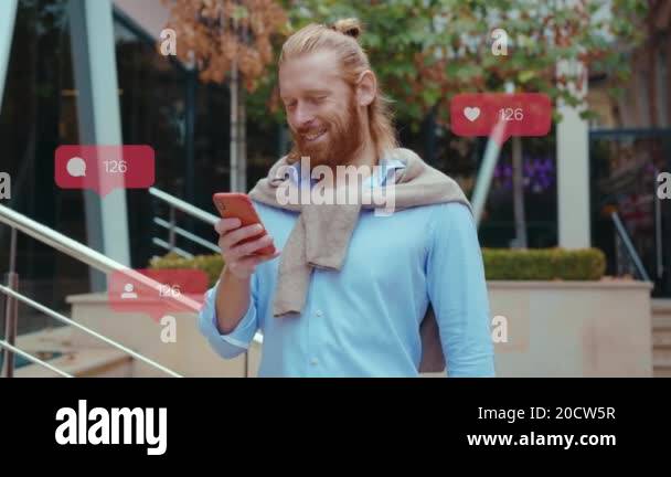 A Man Using Phone Insta Young bearded man use phone stand on city street . Successful elegant ...