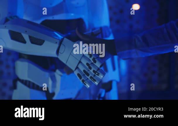 Close Up Hand Of A Businessman Shaking Hands With A Cybernetic Robot