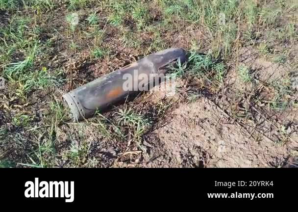 Unexploded shells lie on the ground. Large aerial bombs lie in the ...