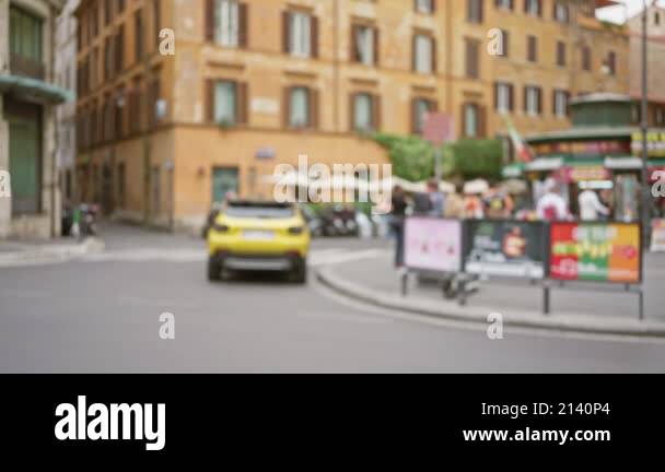 Blurry street scene in rome italy with defocused people and vehicles ...