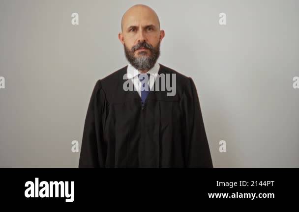 Bearded man in a judge's robe pointing sideways with his thumb ...