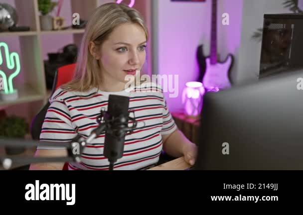 Joyful young blonde streamer saying hello with a friendly gesture ...