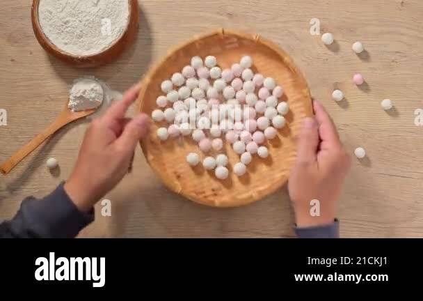 Making Tangyuan (Chinese sweet dumpling) . White and pink rice balls on ...