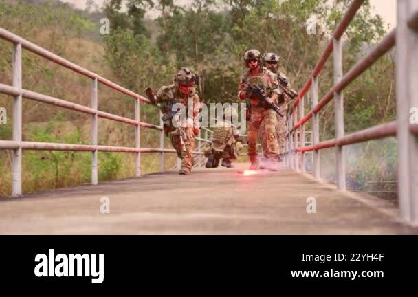 Soldiers Using Yarrow Special forces soldiers gather fight in a war soldiers in camouflage ...