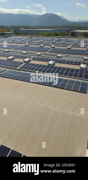 Vertical Screen: Aerial View Of Solar Panels On A Flat Industrial Roof 