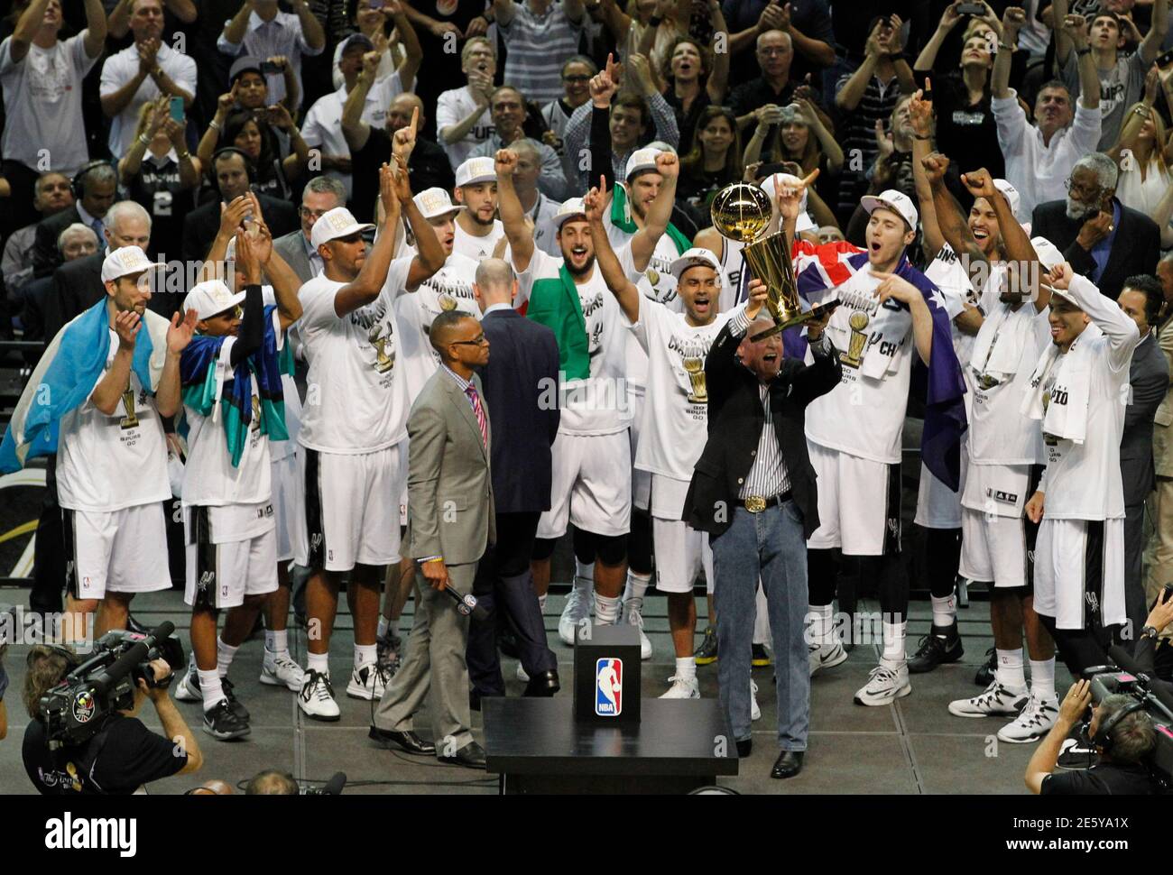 san-antonio-spurs-owner-peter-holt-5th-r-hoists-the-larry-obrien-trophy-in-front-of-the-team-after-they-defeated-the-miami-heat-in-game-5-of-their-nba-finals-basketball-series-in-san-antonio-texas-june-15-2014-reutersmike-stone-united-states-tags-sports-basketball-tpx-images-of-the-day-2E5YA1X.jpg