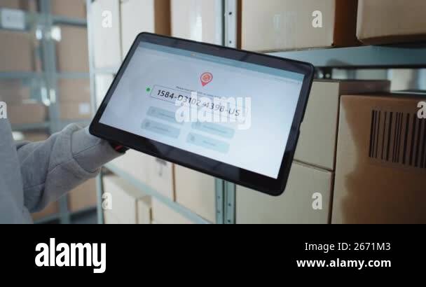 Postal Warehouse Worker Scans QR Code on Cardboard Box with Barcode ...