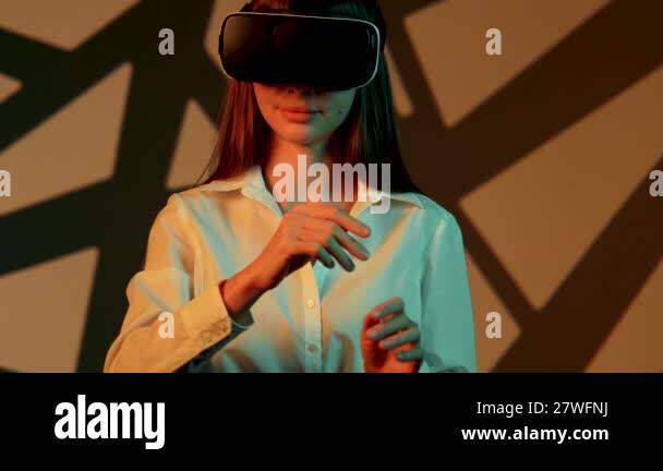 Woman engages with immersive technology while wearing virtual reality ...