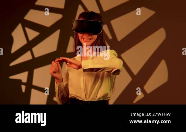 Woman engages with immersive technology while wearing virtual reality ...