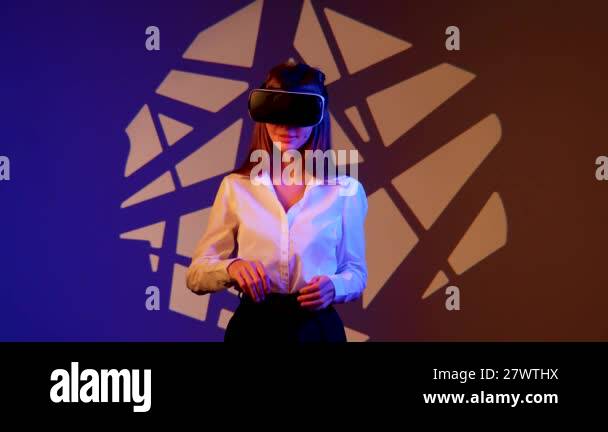 Woman engages with immersive technology while wearing virtual reality ...