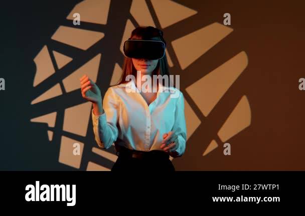 Woman engages with immersive technology while wearing virtual reality ...