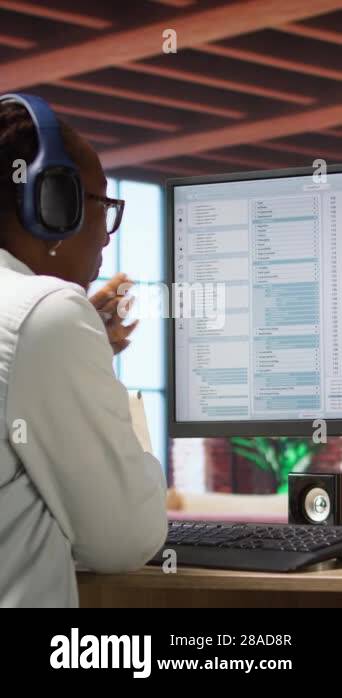 Vertical video Jolly engineer in home office working on computer ...