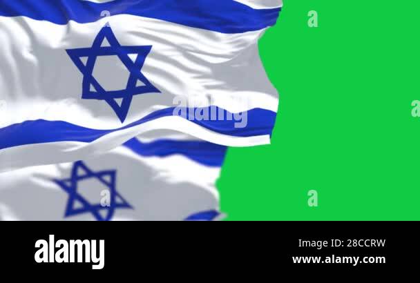 State of Israel national flags waving in the wind isolated on green ...