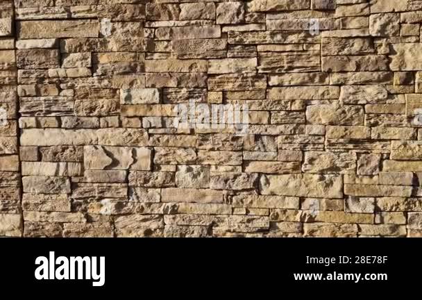 Modern gray brown, beige, metal door at the house lined with stone ...
