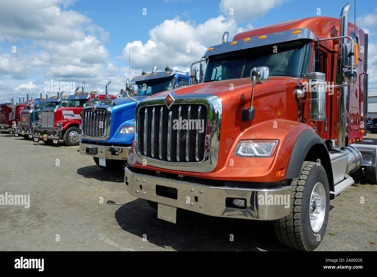A lineup of semi tractor trailer trucks at a show Stock Photo