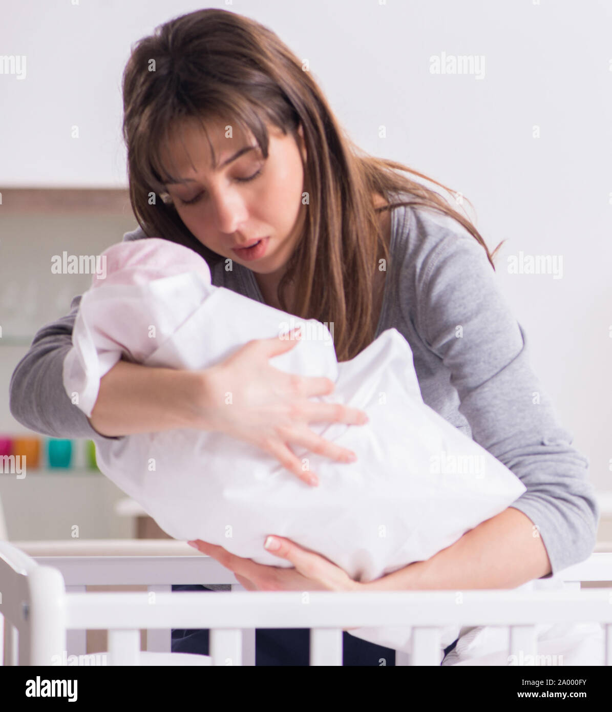 The young dad cannot stand baby crying Stock Photo - Alamy