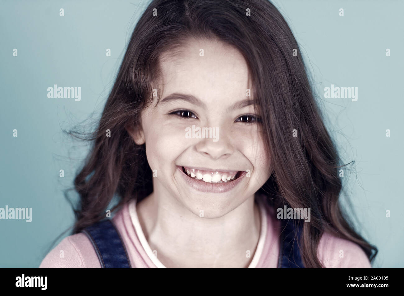 Beautiful little girl caucasian with long dark hair happy smiling on ...