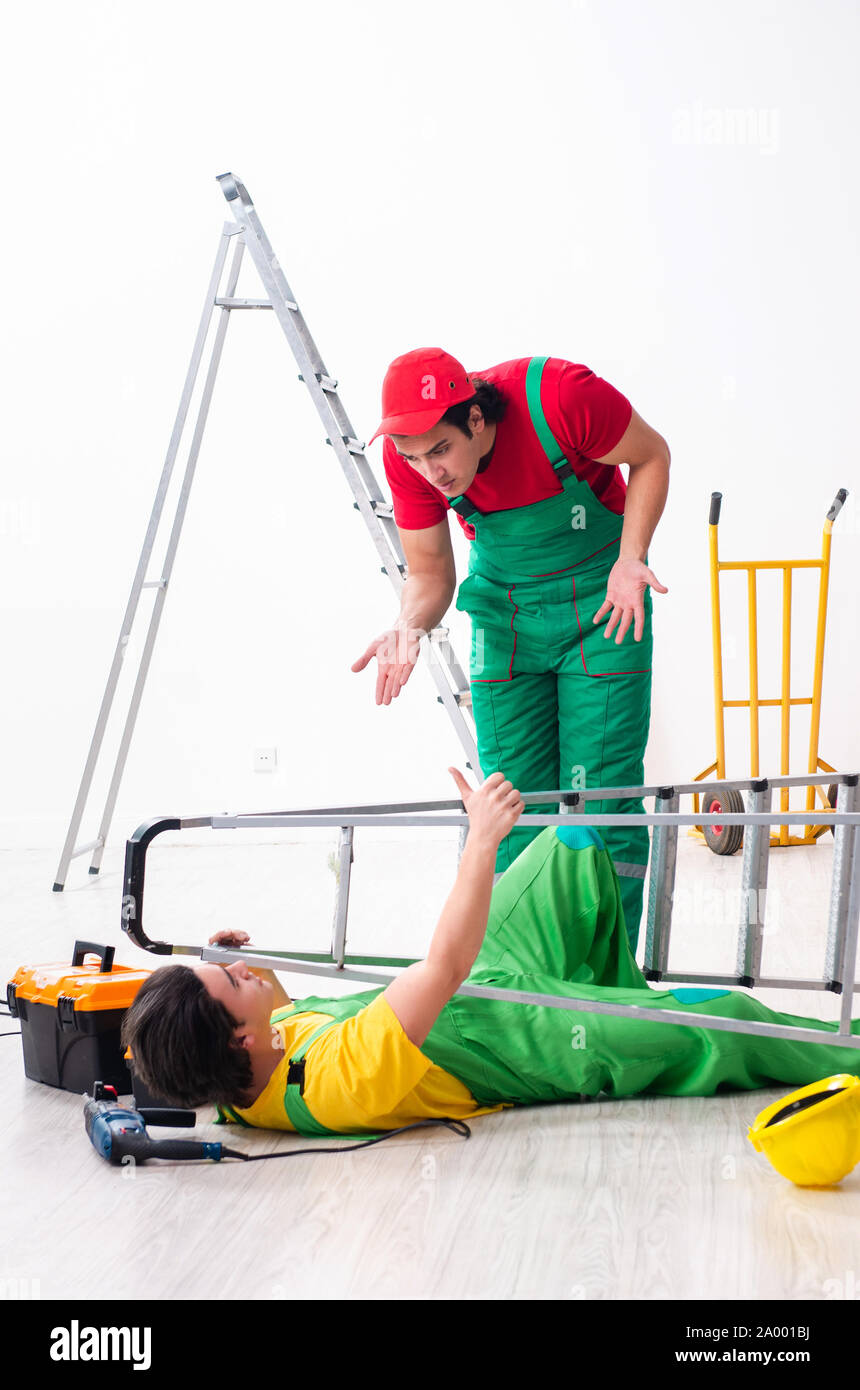 The injured worker and his workmate Stock Photo - Alamy