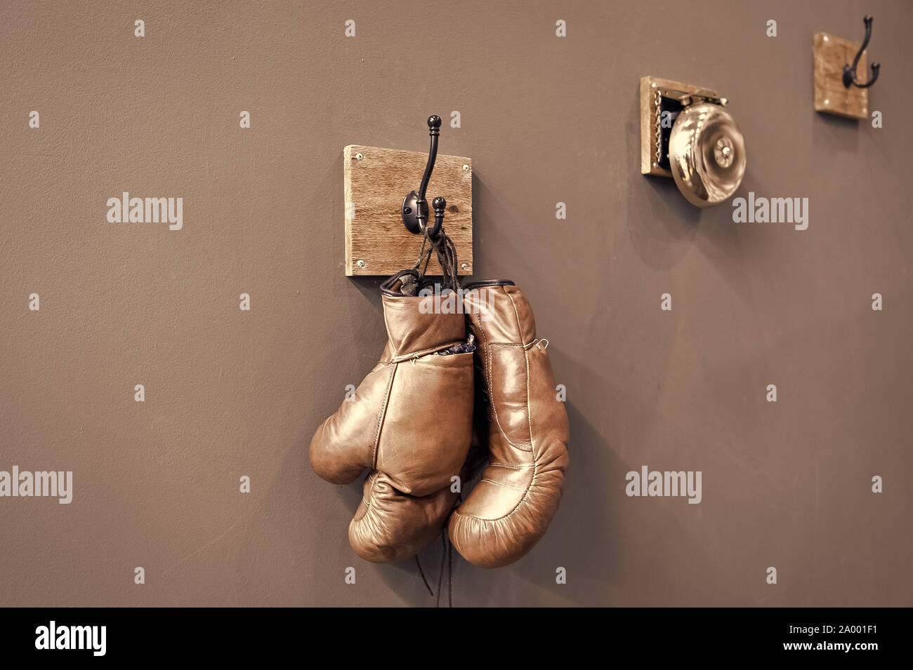 Boxing school. Final sparring. Vintage boxing gloves hang on hook wall