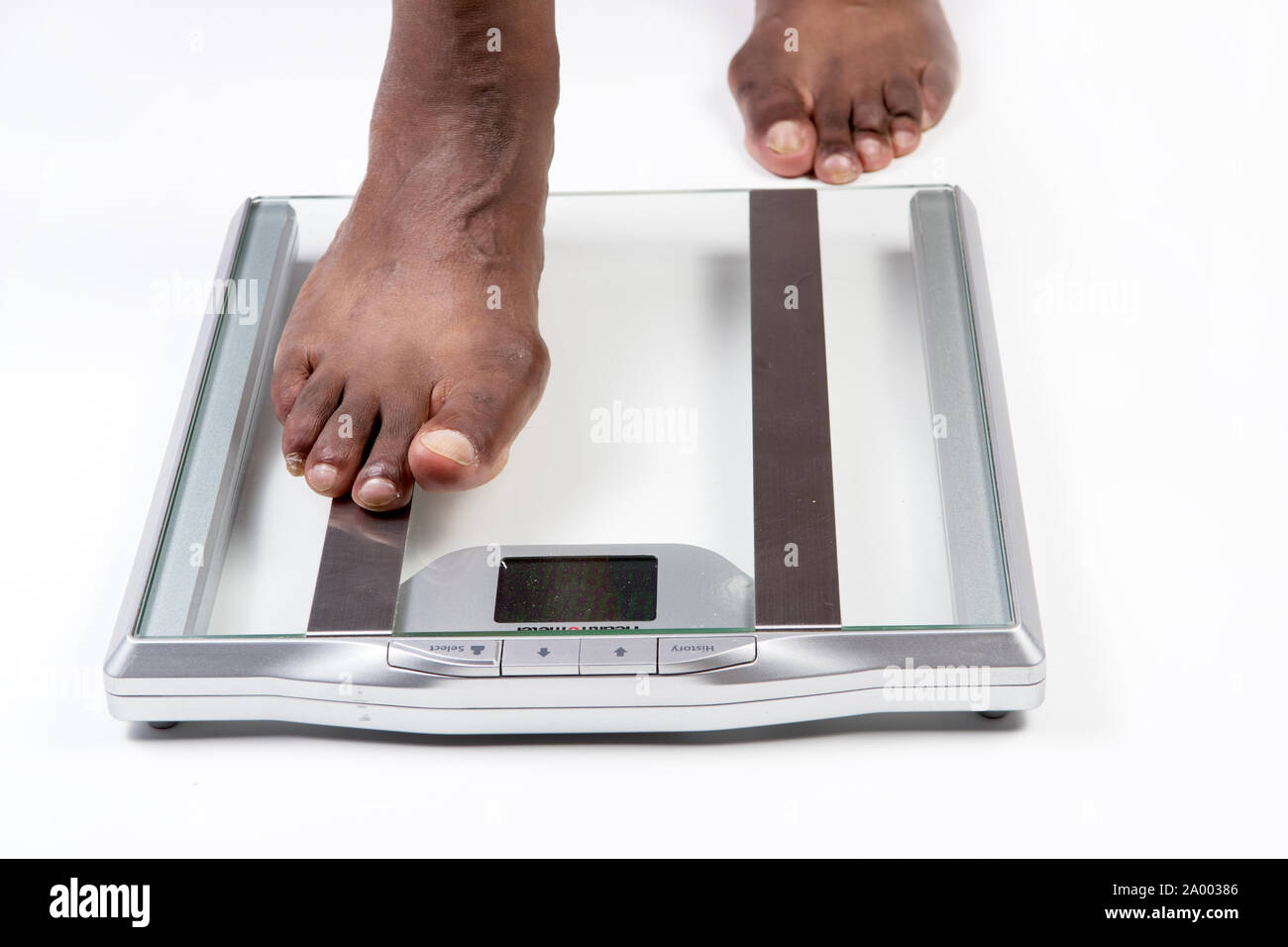 https://c8.alamy.com/comp/2A00386/male-feet-stepping-on-electronic-scales-for-weight-control-on-white-background-the-concept-of-slimming-and-weight-loss-2A00386.jpg