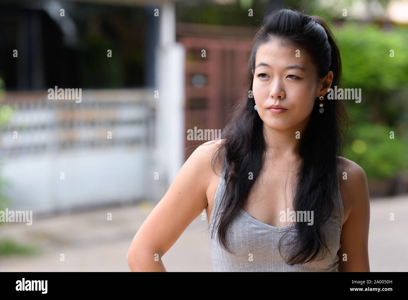 Portrait of beautiful Asian woman thinking and looking away Stock Photo ...